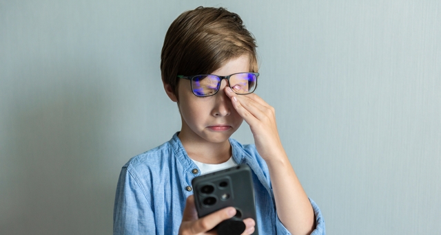 little boy suffering from digital eye strain